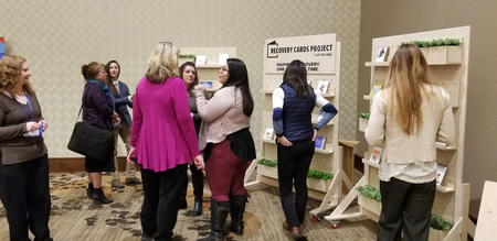 women talking at posters